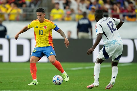 James Rodriguez dribbles past Joel Campbell